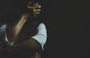 Abused young woman trying to hide and defend herself