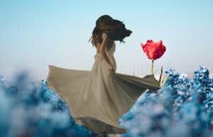 The World’s Rarest Personality Type Has These Strengths & Weaknesses Woman twirling in a field, standing out, being different