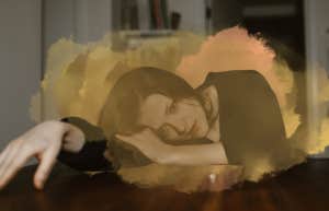 How Long Does It Take To Get Over A Breakup? Lies We Tell Ourselves That Prolong A Broken Heart Woman laying on desk consumed by her thoughts, post breakup