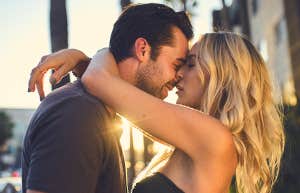 Man and woman kissing passionately in the street
