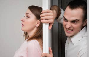 Young woman in horror trying to hide from her boyfriend