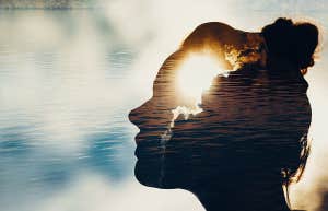 strong woman silhouette with light shining through brain