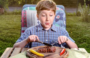 boy eating a steak