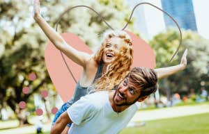 happy couple being playful in the park on a sunny day