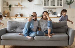 miserable parents kids running around them being wild