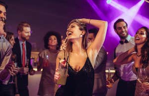 woman center of attention dancing freely at club