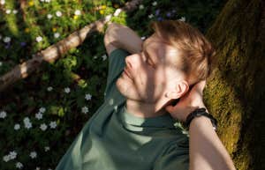 man relaxing on tree