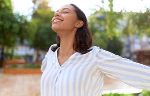 Woman practicing mindset trick to raise her confidence