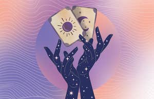 hands holding tarot cards for may 26 reading