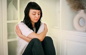 Woman honoring her inner child, hugging her inner child 