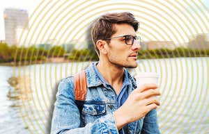 Handsome man standing casually, drawing people in 