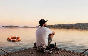 Man waiting, looking out into vast nature. Realizing no one was coming to save him.