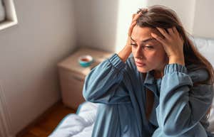 Emotional woman recovering from hysterectomy at home