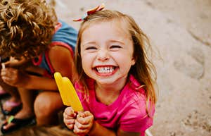 Young child happily eating a popsicle