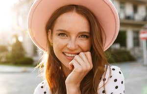 cheery woman in a pink hat
