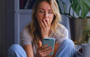 Woman on phone realizes she has subtly been sabotaging her relationship.
