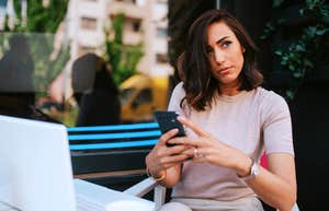 Angry woman deciding if she should text her partner