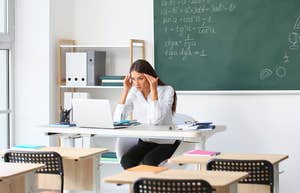 Teacher worried while sitting at her desk