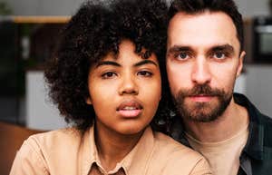 Couple in relationship that survived cheating, sitting next to each other.