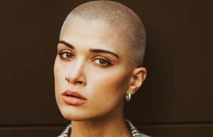 beautiful woman with shaved head looking serious