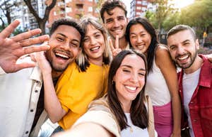 group of millennial friends smiling at camera