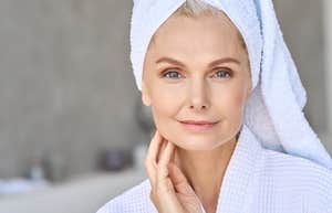 Woman in her sixties getting ready for the day in her bathroom 
