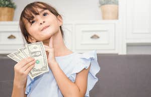 Little girl holding Christmas money