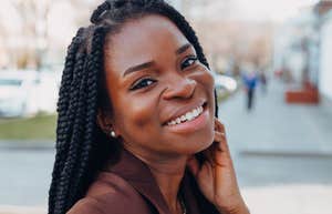 Subtle Traits Of A Good-Hearted Person, According To Psychology beautiful woman with braids smiling big