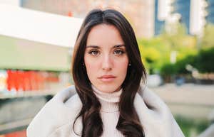 Front view of serious young woman looking at camera. 