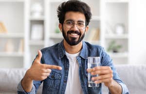 smiling man holding glass of water