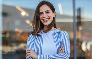classy woman smiling arms crossed