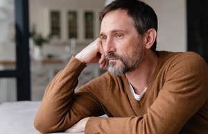 confused, concerned middle aged man looking off into the distance