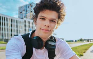 Selfie portrait of young man with curly hair