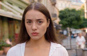 sad woman standing on the street