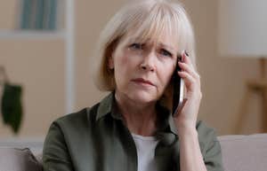 Phrases That Offend Boomers But Don’t Bother Younger Generations At All Old woman looking offended talking on the phone.