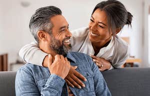 smiling couple looking at each other happily