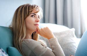 Woman thinking about why she feels so emotionally exhausted after spending time with family