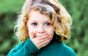 Child not allowed to say these words, covering mouth. 