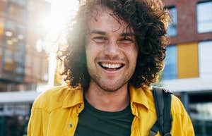 cheerful smiling man walking outside