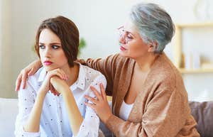 woman secretly resenting mother comforting her