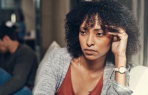 woman holding head in pain from toxic relationship