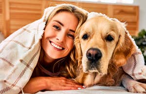 Person sharing a bed with their pet. 