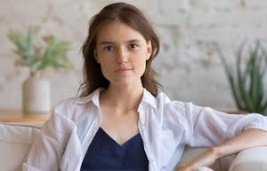 middle class woman sitting in living room unable to afford more