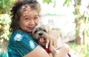Reasons People Who Would Rather Just Hang Out With Their Dogs As They Get Older Usually Have older woman snuggling her dog outside