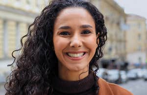 happy woman with a complex mind standing outside