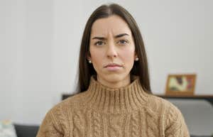 introverted woman looking stressed at home