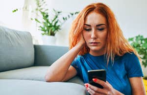 Deeply Unhappy People Almost Always Send These Texts During Casual Conversations deeply unhappy woman looking at her phone