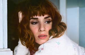 Bored woman staring off thoughtfully, symbolizing emotional emptiness and the quiet realization that somethingâs missing in her relationship.