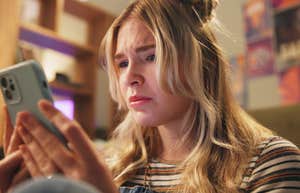 If Someone Is A Chronic People-Pleaser, They'll Send These Texts During Casual Conversation people-pleasing woman worried texting on phone