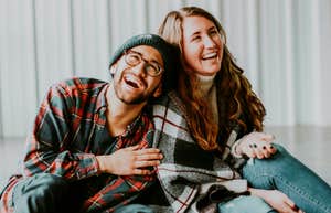 Playful couple laughing together, illustrating ways the most romantic couples keep their marriage full of sparks